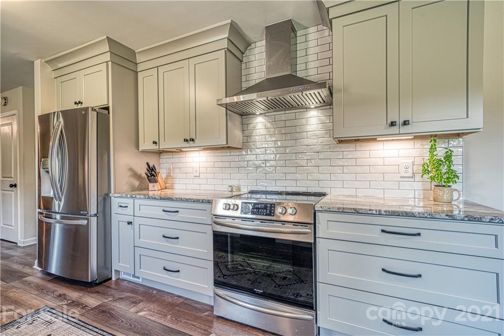 3705 River Road Hickory, NC 28602 - Photo 19 of 48 a kitchen with granite countertop cabinets and steel stainless steel appliances