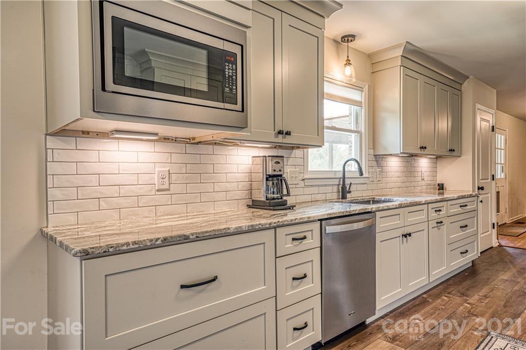 3705 River Road Hickory, NC 28602 - Photo 20 of 48 a kitchen with granite countertop white cabinets white stainless steel appliances with a sink and dishwasher
