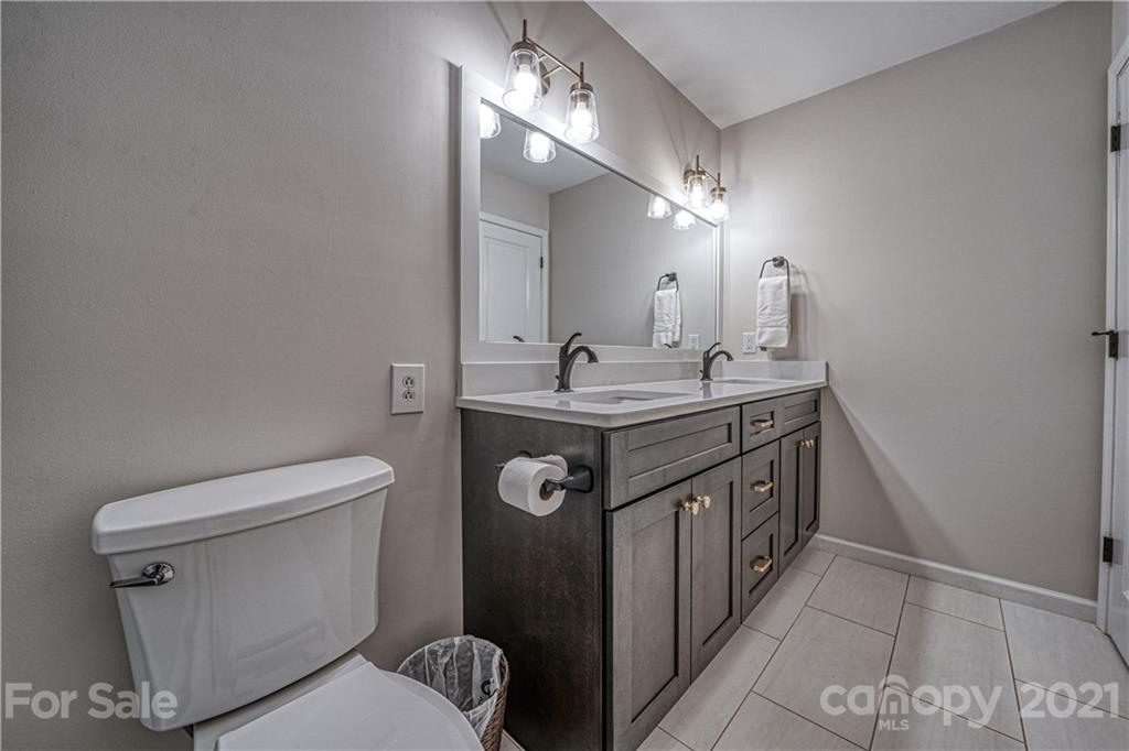 3705 River Road Hickory, NC 28602 - Photo 26 of 48 a bathroom with a sink a toilet a mirror and vanity