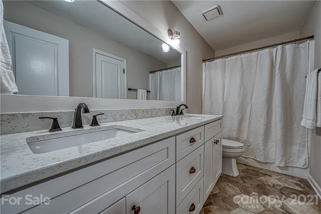 3705 River Road Hickory, NC 28602 - Photo 30 of 48 a bathroom with a double vanity sink and a toilet