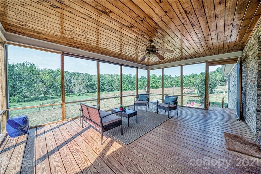 3705 River Road Hickory, NC 28602 - Photo 35 of 48 a living room with furniture and floor to ceiling windows