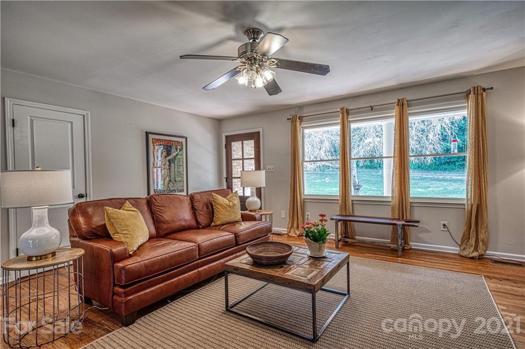 3705 River Road Hickory, NC 28602 - Photo 9 of 48 a living room with furniture and a floor to ceiling window