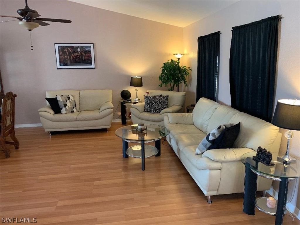 26324 Hong Kong Road Punta Gorda, FL 33983 - Photo 11 of 18 a living room with furniture and wooden floor
