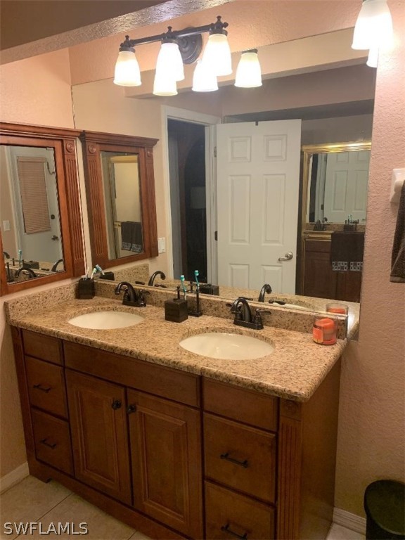26324 Hong Kong Road Punta Gorda, FL 33983 - Photo 15 of 18 a bathroom with a granite countertop sink and a mirror