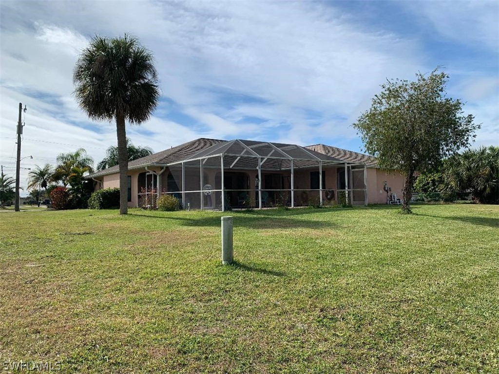 26324 Hong Kong Road Punta Gorda, FL 33983 - Photo 17 of 18 a view of a house with a yard and potted plants
