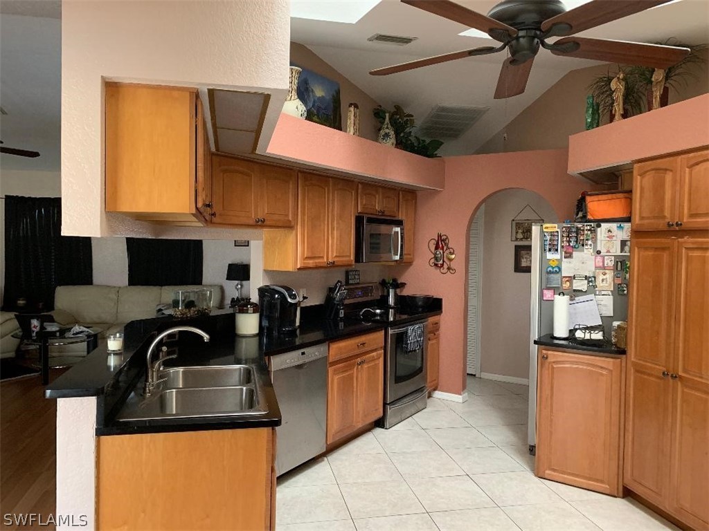 26324 Hong Kong Road Punta Gorda, FL 33983 - Photo 4 of 18 a kitchen with stainless steel appliances granite countertop a refrigerator and a sink