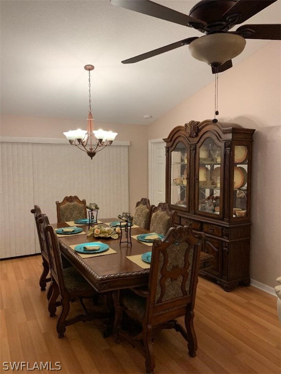 26324 Hong Kong Road Punta Gorda, FL 33983 - Photo 7 of 18 a view of a dining room with furniture and wooden floor