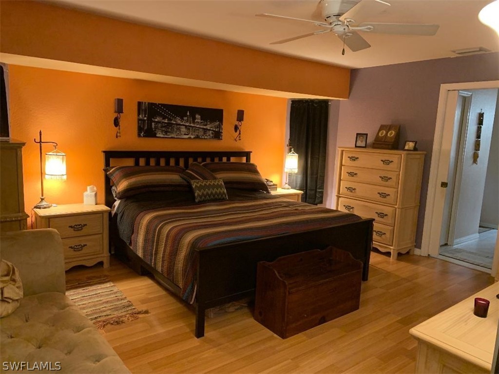 26324 Hong Kong Road Punta Gorda, FL 33983 - Photo 8 of 18 a bedroom with a bed and furniture