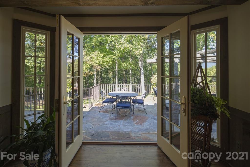 925 Hunting Country Road Tryon, NC 28782 - Photo 22 of 41 a dining room with furniture and a floor to ceiling window