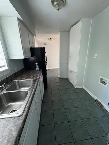 a kitchen with a sink and refrigerator