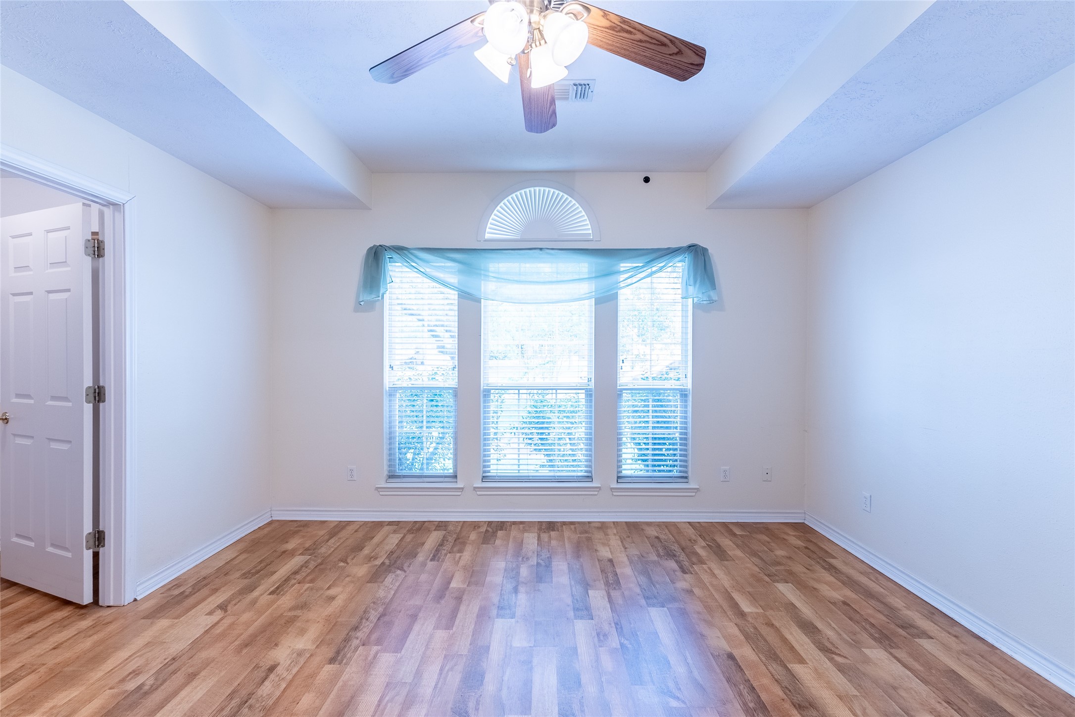 4802 Treadgold Lane Bryan, TX 77802 - Photo 15 of 28 a view of an empty room with wooden floor and a window