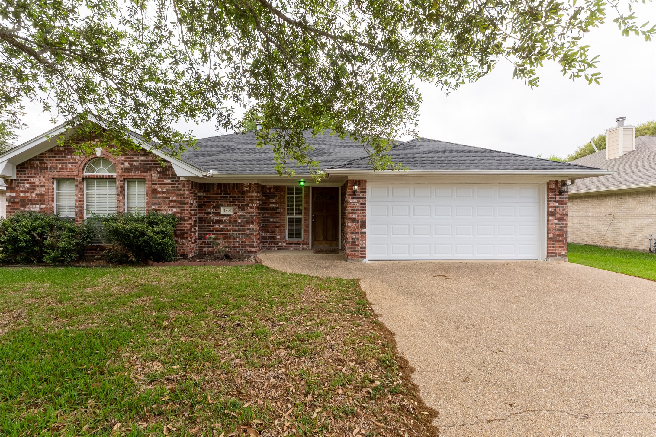 4802 Treadgold Lane Bryan, TX 77802 - Photo 2 of 28 a front view of a house with a yard and garage