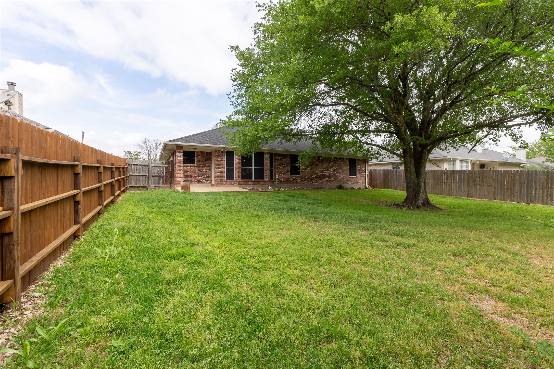 4802 Treadgold Lane Bryan, TX 77802 - Photo 26 of 28 a view of a house with a yard and sitting area
