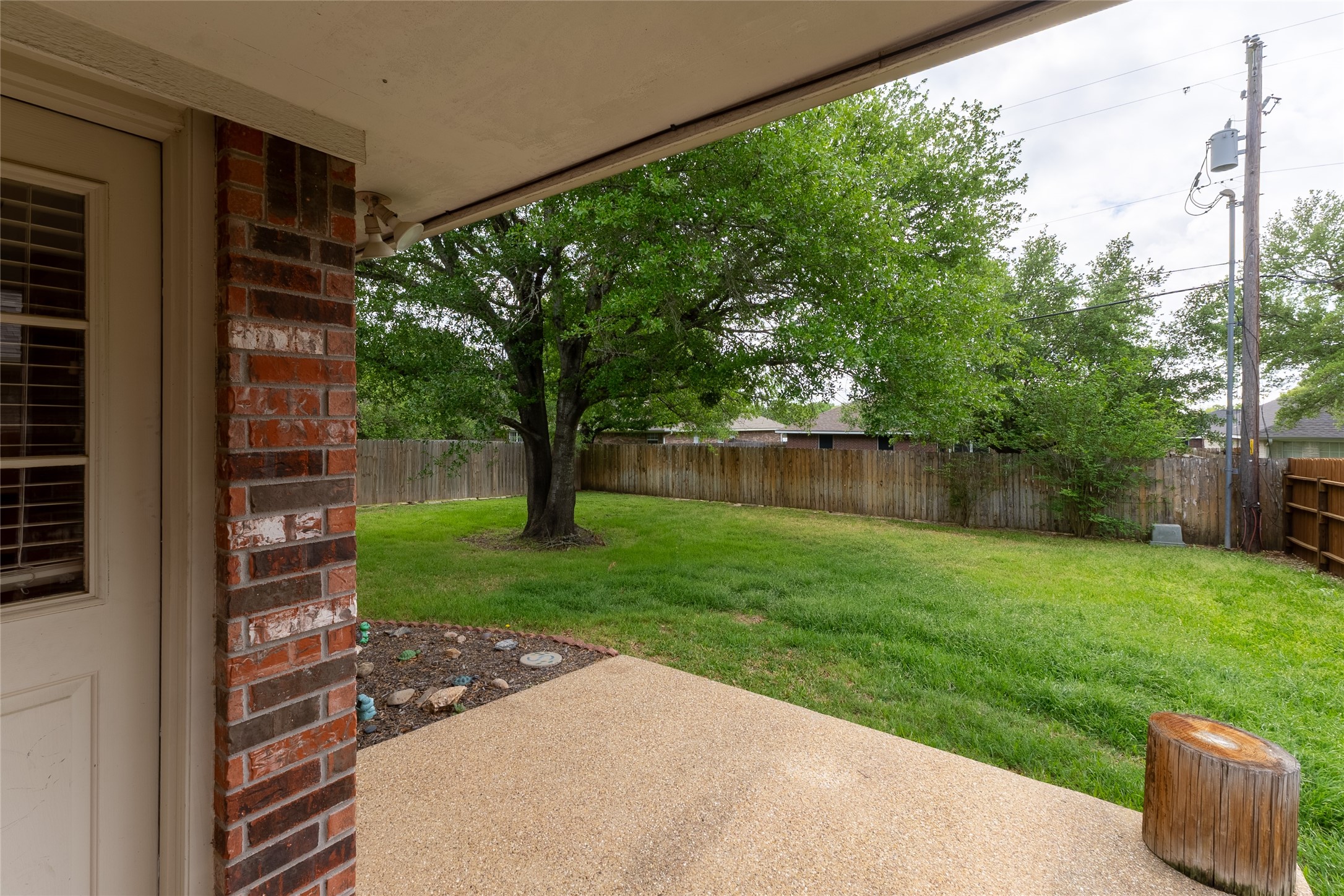 4802 Treadgold Lane Bryan, TX 77802 - Photo 27 of 28 a view of a backyard with plants and large tree