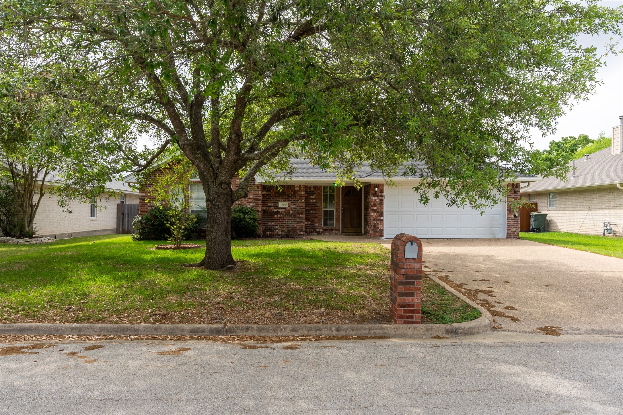 4802 Treadgold Lane Bryan, TX 77802 - Photo 5 of 28 a front view of a house with a yard and a garage