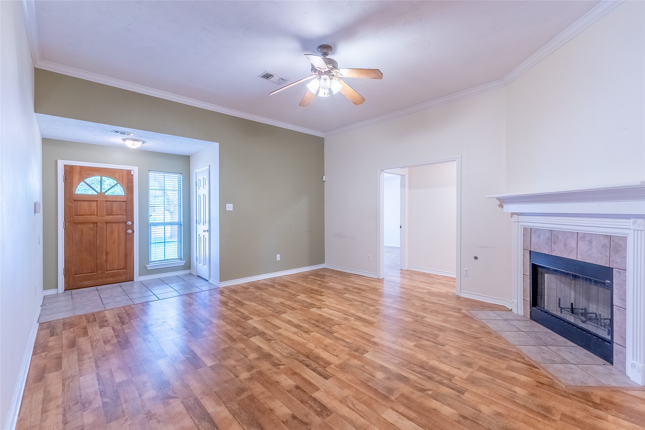 4802 Treadgold Lane Bryan, TX 77802 - Photo 8 of 28 a view of an empty room with wooden floor fireplace and a window