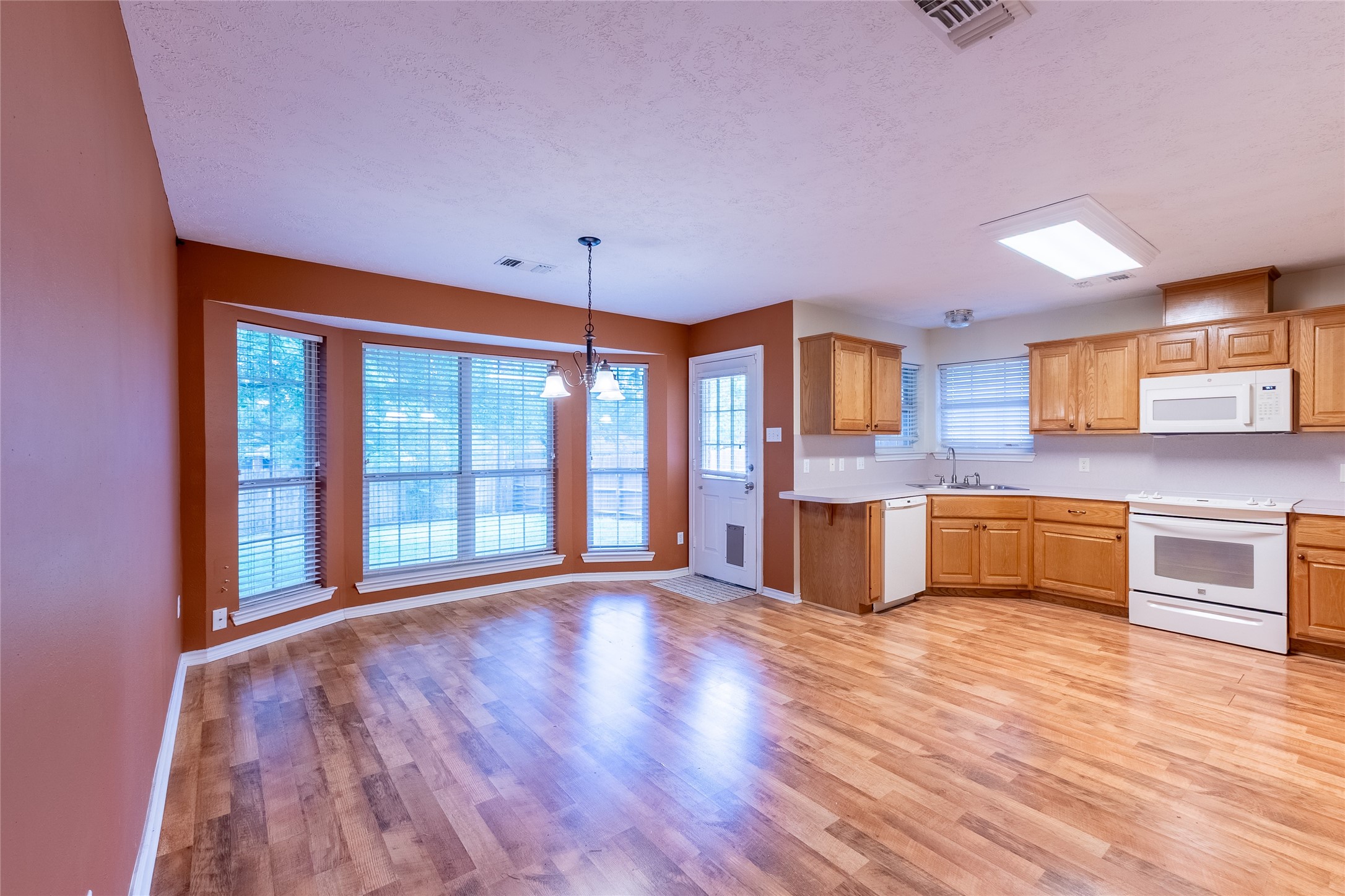 4802 Treadgold Lane Bryan, TX 77802 - Photo 10 of 28 a view of a kitchen with a sink and microwave