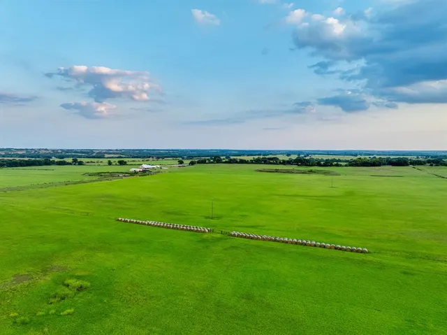 a view of a field with an ocean