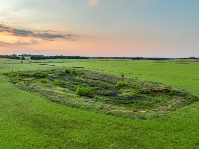 an aerial view of a houses with a yard