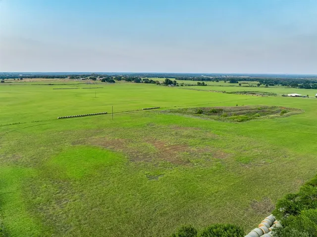 a view of a field with an ocean