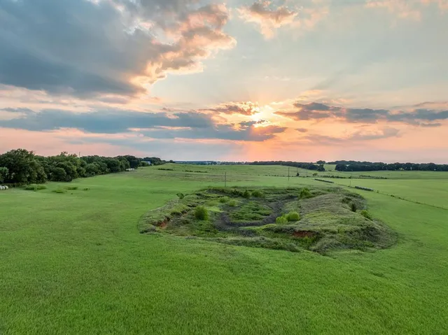 a view of a green field with clear sky