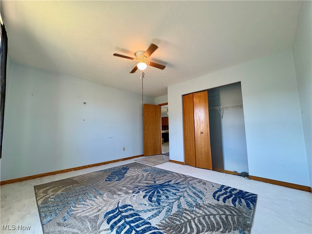 3333 Force Road Shreve, OH 44676 - Photo 20 of 26 Unfurnished bedroom with ceiling fan, a closet, and a textured ceiling
