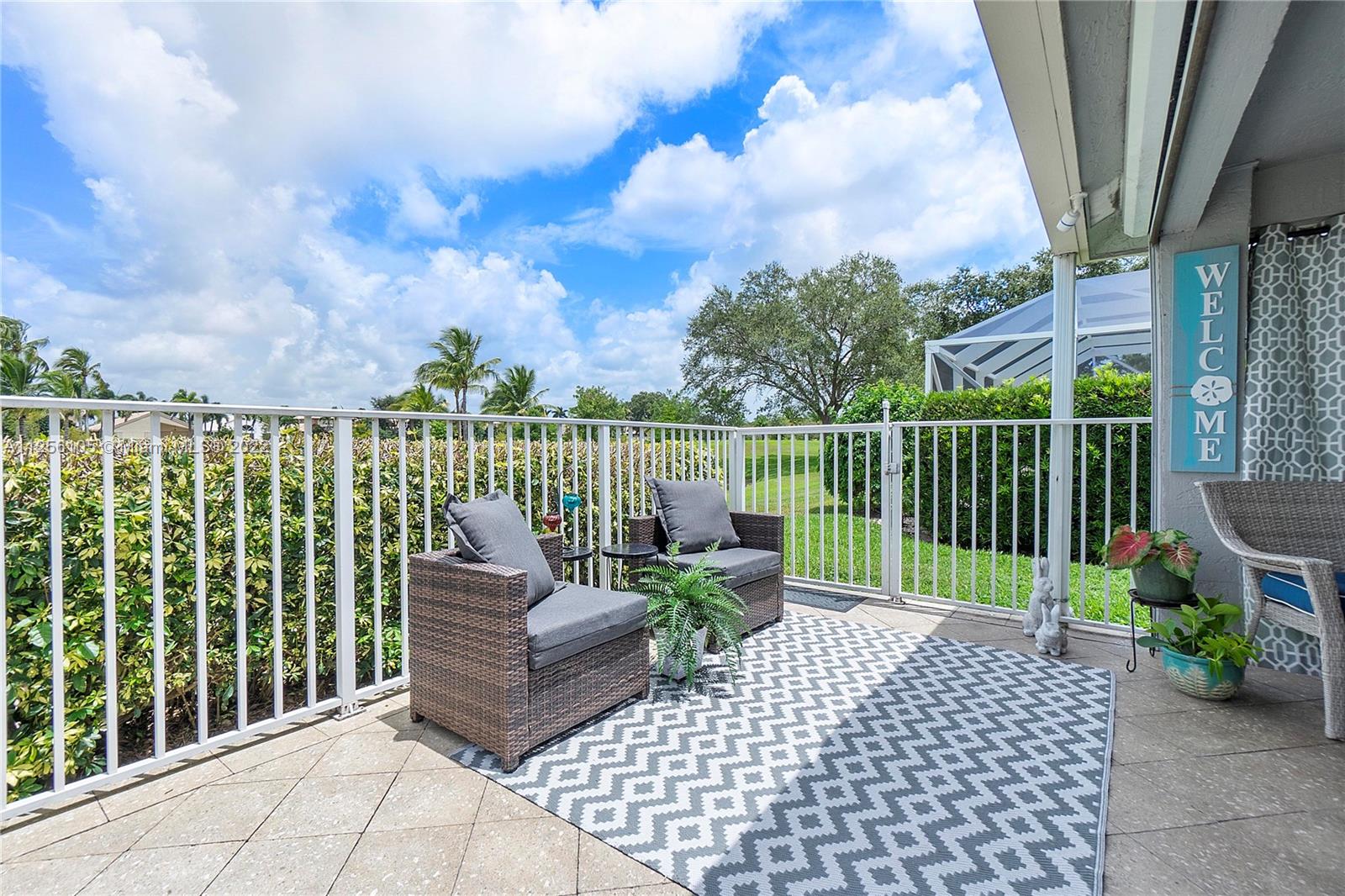 7677 Doubleton Drive Delray Beach, FL 33446 - Photo 11 of 42 a view of a chairs and table on the terrace