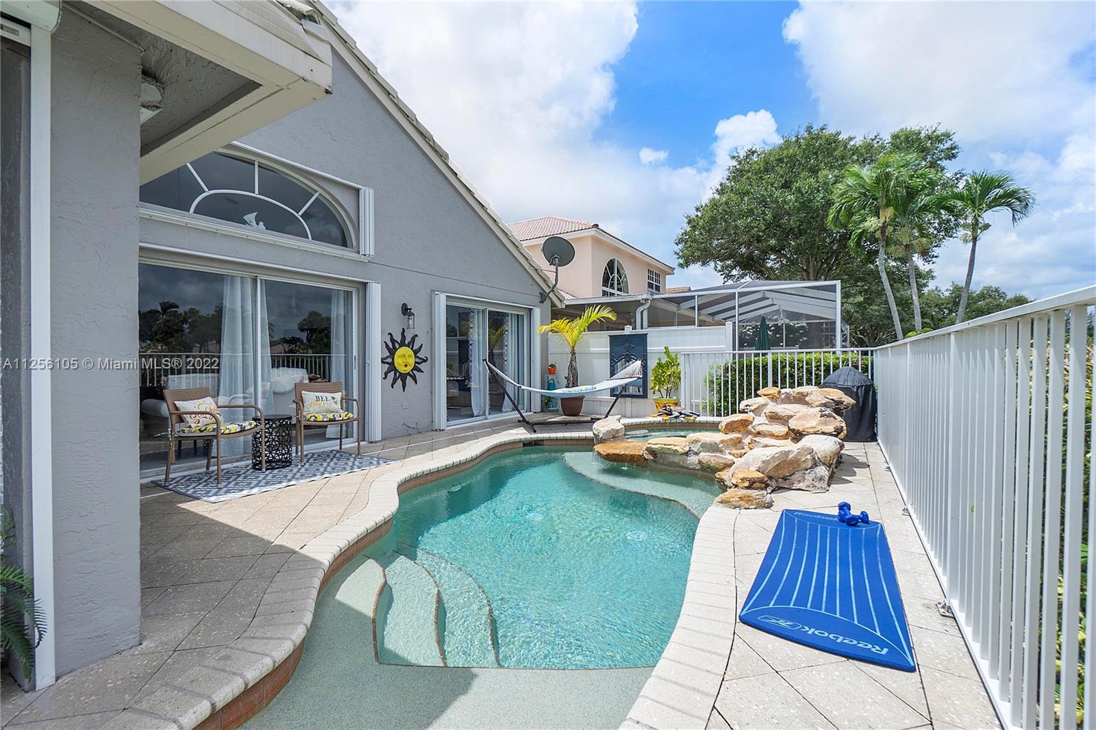 7677 Doubleton Drive Delray Beach, FL 33446 - Photo 12 of 42 a view of a dinning table and chairs in patio of the house