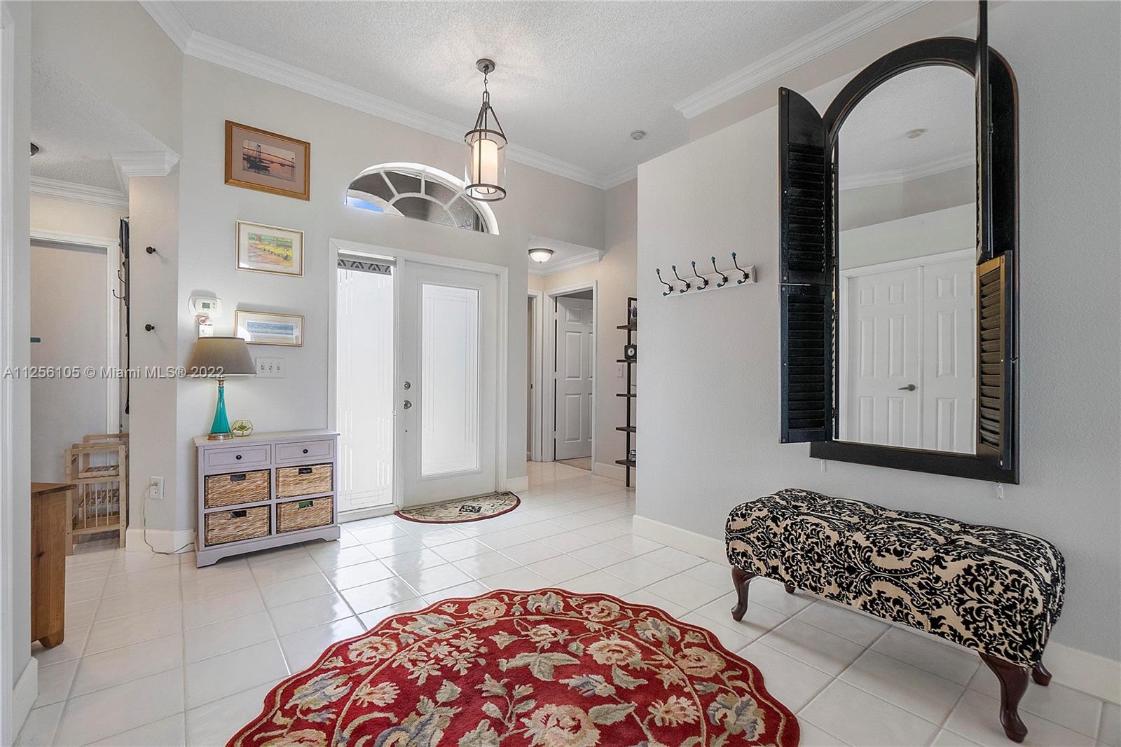 7677 Doubleton Drive Delray Beach, FL 33446 - Photo 14 of 42 a bedroom with furniture and a chandelier