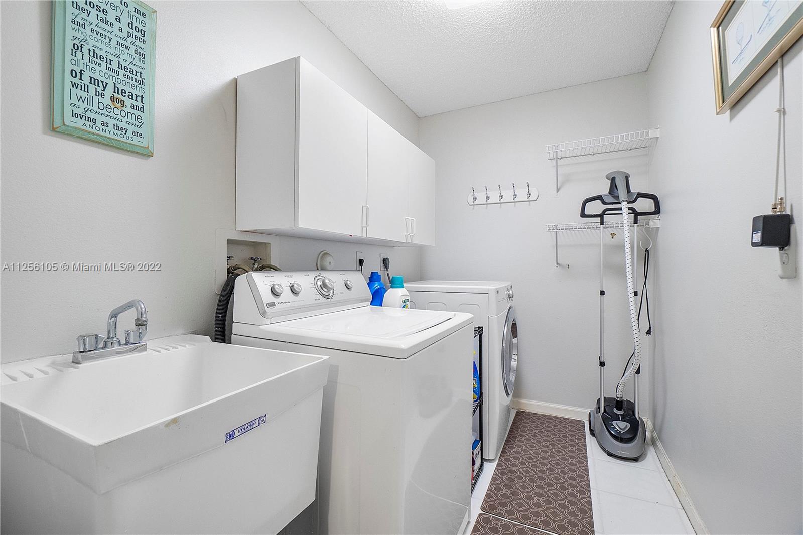 7677 Doubleton Drive Delray Beach, FL 33446 - Photo 18 of 42 a utility room with dryer and washer