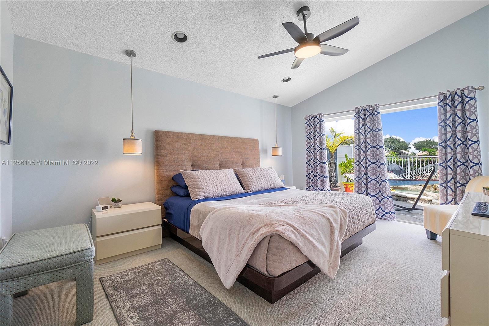 7677 Doubleton Drive Delray Beach, FL 33446 - Photo 20 of 42 a bedroom with a bed a couch and a window