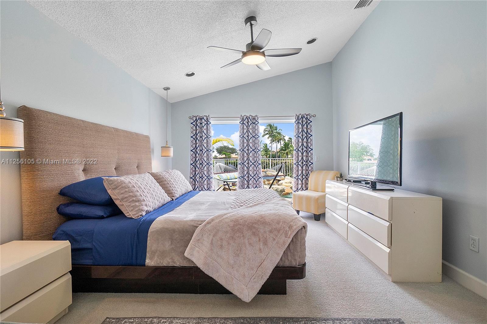 7677 Doubleton Drive Delray Beach, FL 33446 - Photo 21 of 42 a large bedroom with a large bed couch and windows