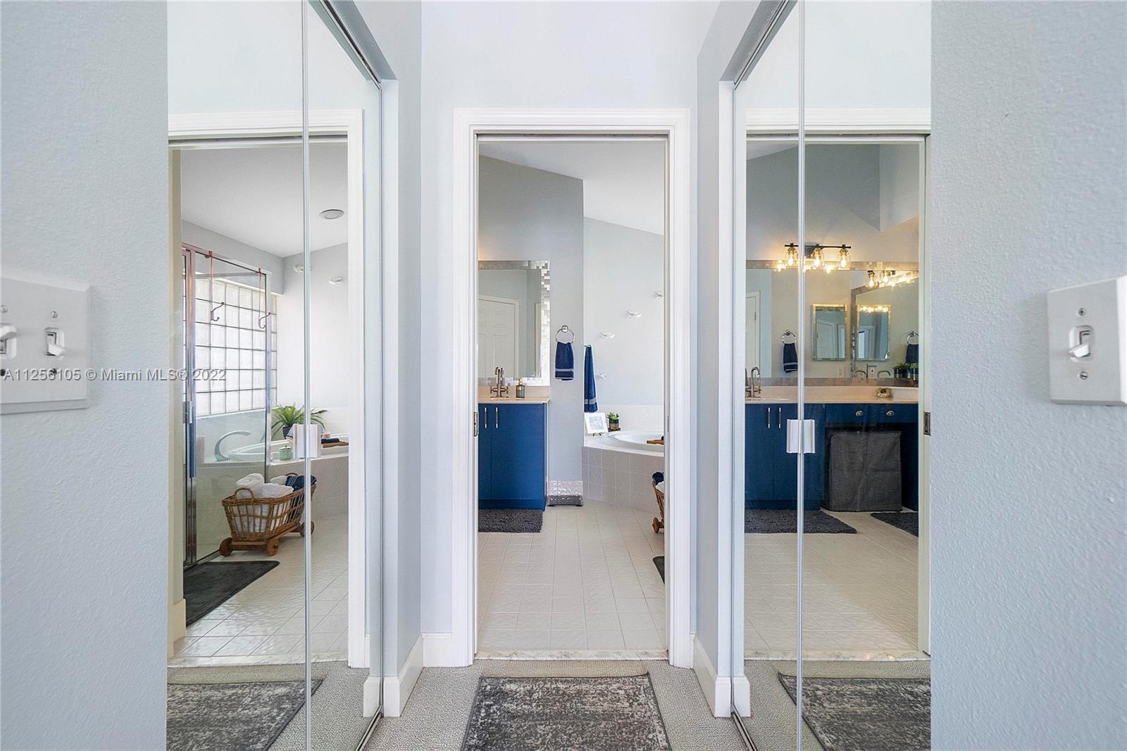 7677 Doubleton Drive Delray Beach, FL 33446 - Photo 22 of 42 a view of a hallway with dining room and wooden floor