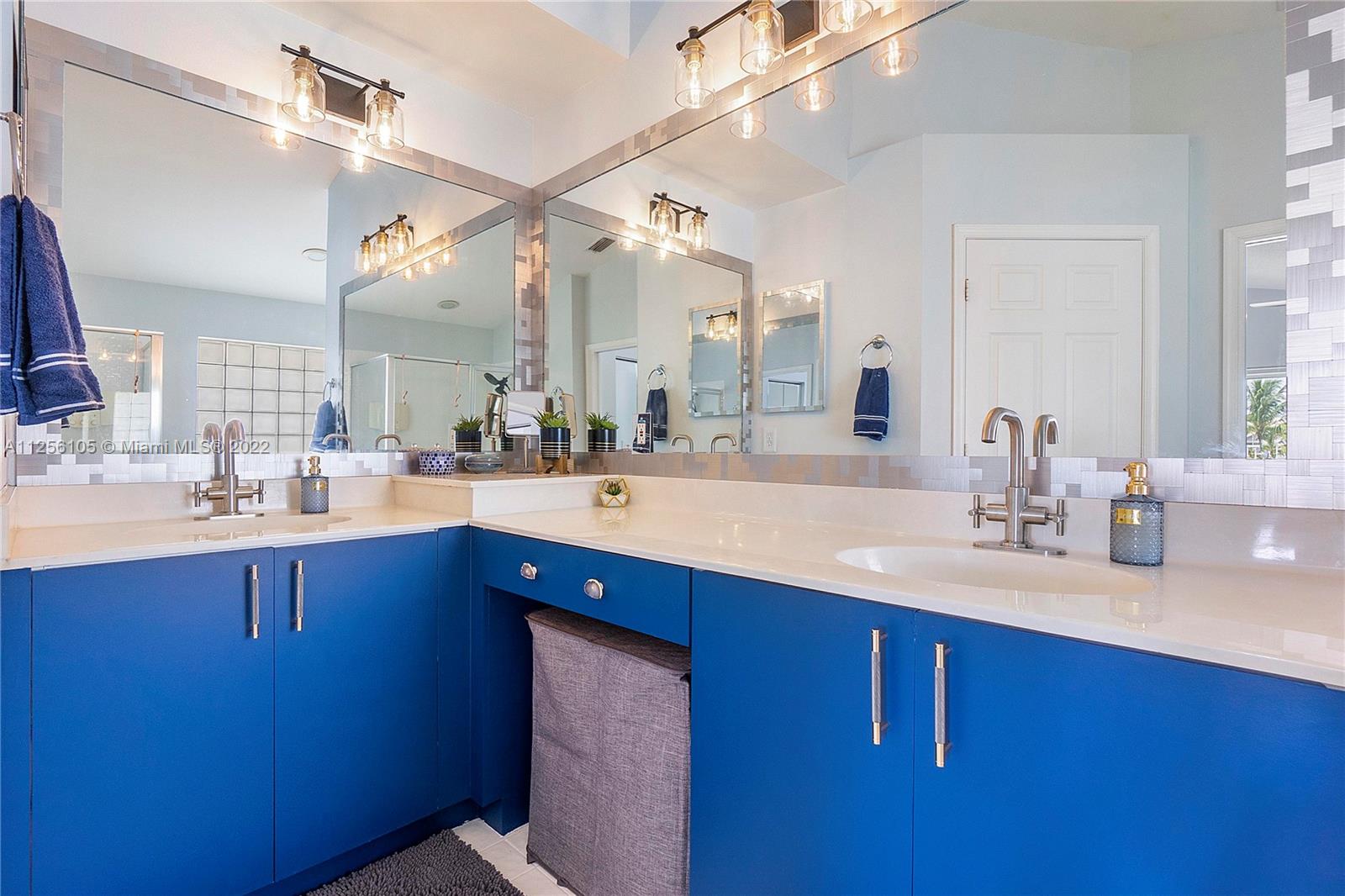 7677 Doubleton Drive Delray Beach, FL 33446 - Photo 24 of 42 a bathroom with a double vanity sink and a mirror