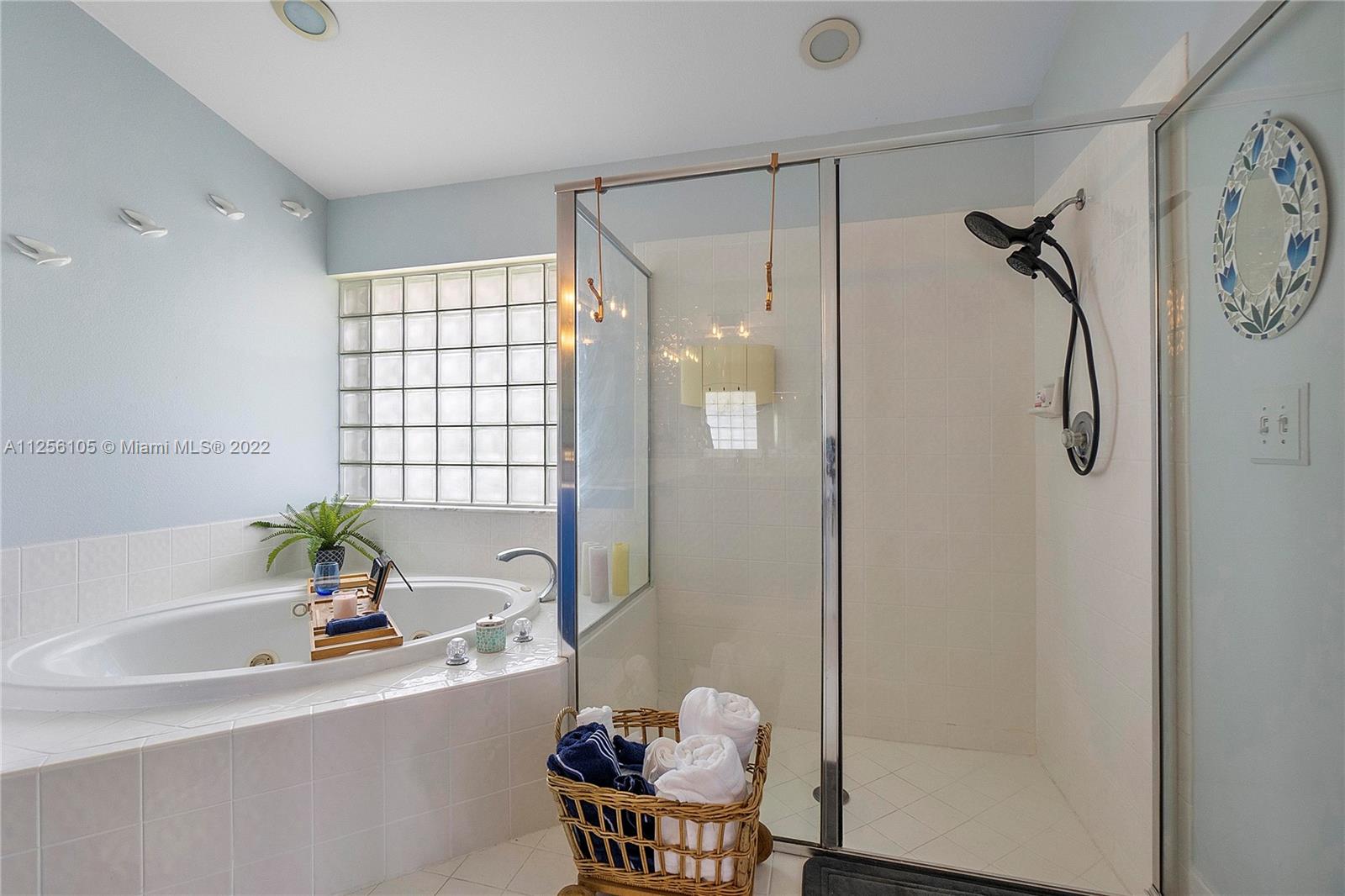 7677 Doubleton Drive Delray Beach, FL 33446 - Photo 25 of 42 a bathroom with a bathtub and a shower