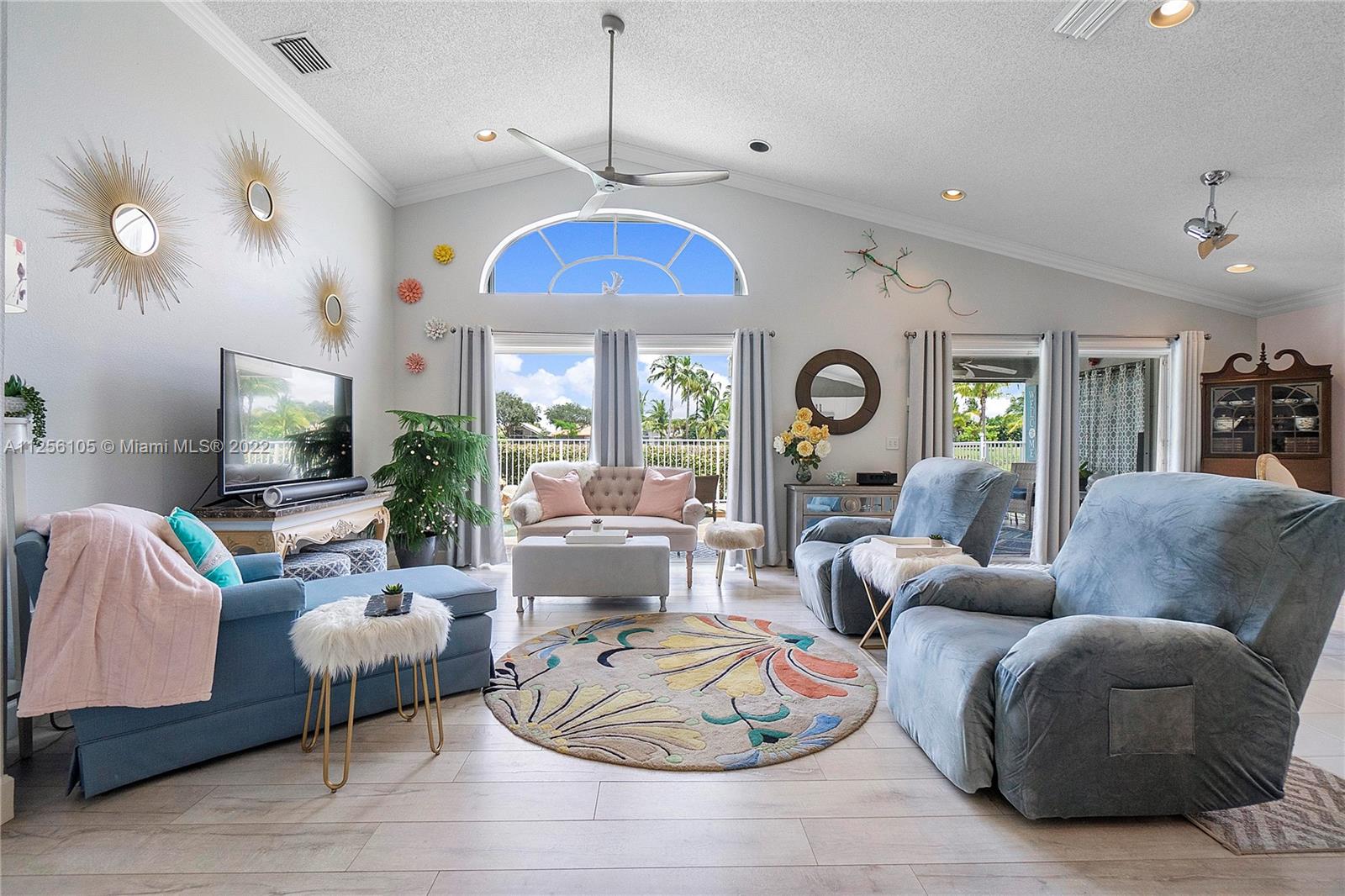 7677 Doubleton Drive Delray Beach, FL 33446 - Photo 27 of 42 a living room with furniture chandelier and a flat screen tv