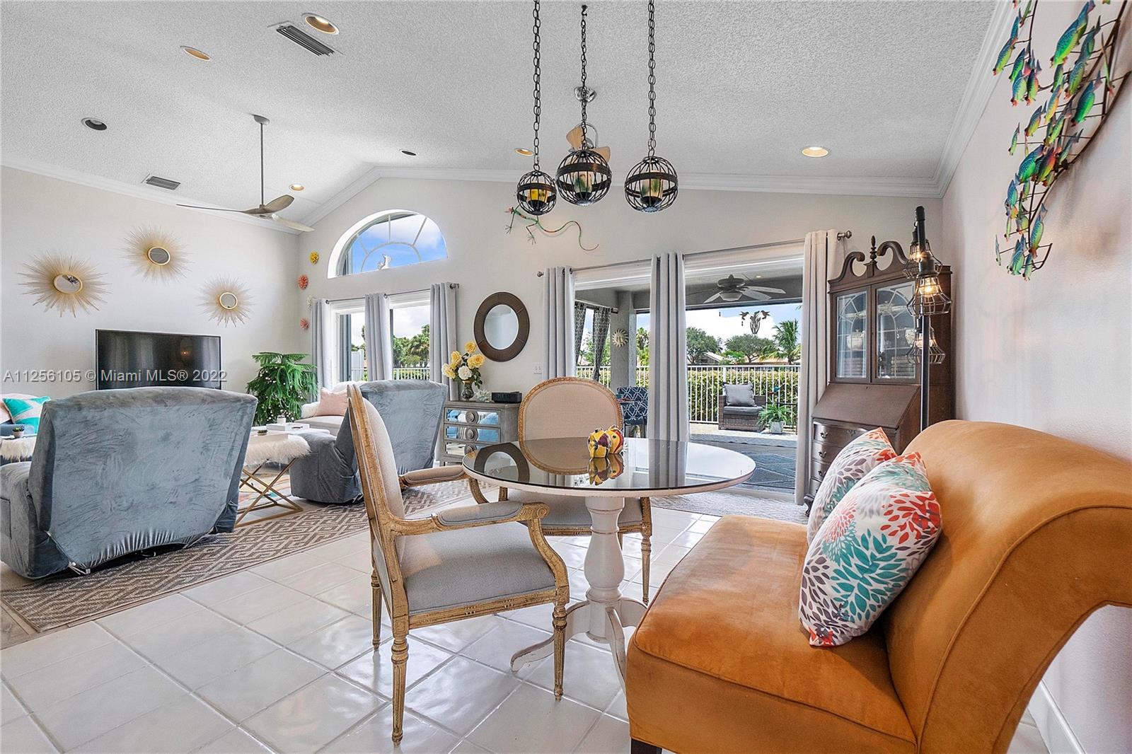 7677 Doubleton Drive Delray Beach, FL 33446 - Photo 29 of 42 a living room with fireplace furniture and a large window