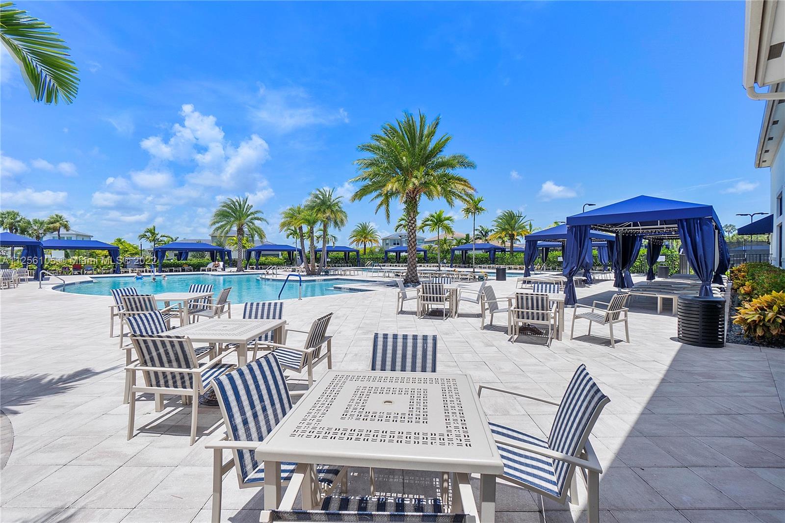7677 Doubleton Drive Delray Beach, FL 33446 - Photo 35 of 42 a view of a patio with a dining table and chairs with a patio