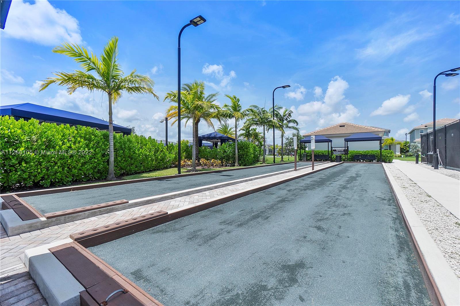 7677 Doubleton Drive Delray Beach, FL 33446 - Photo 36 of 42 a front view of a house with a yard and a garage