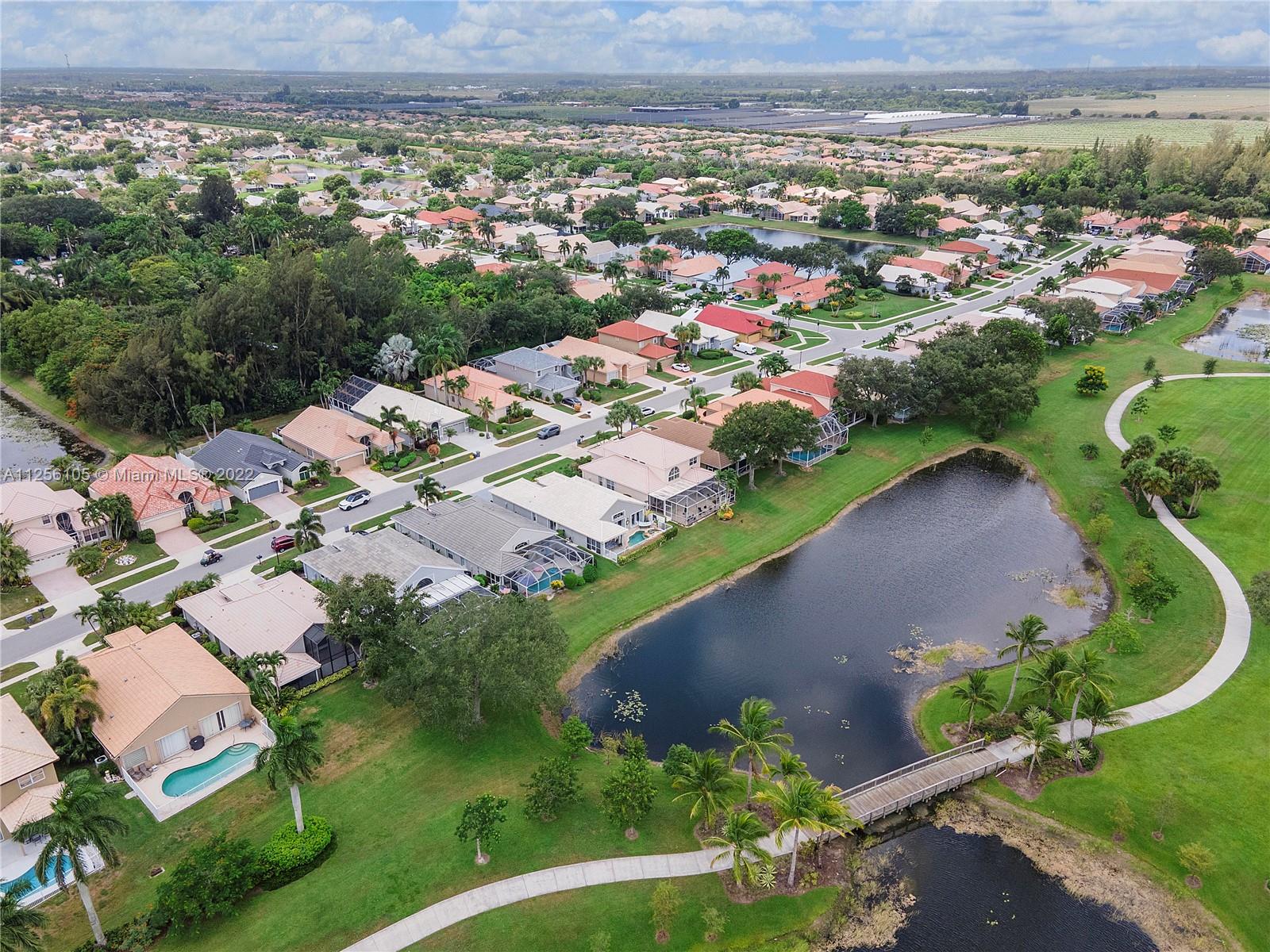 7677 Doubleton Drive Delray Beach, FL 33446 - Photo 4 of 42 an aerial view of residential houses with outdoor space and trees