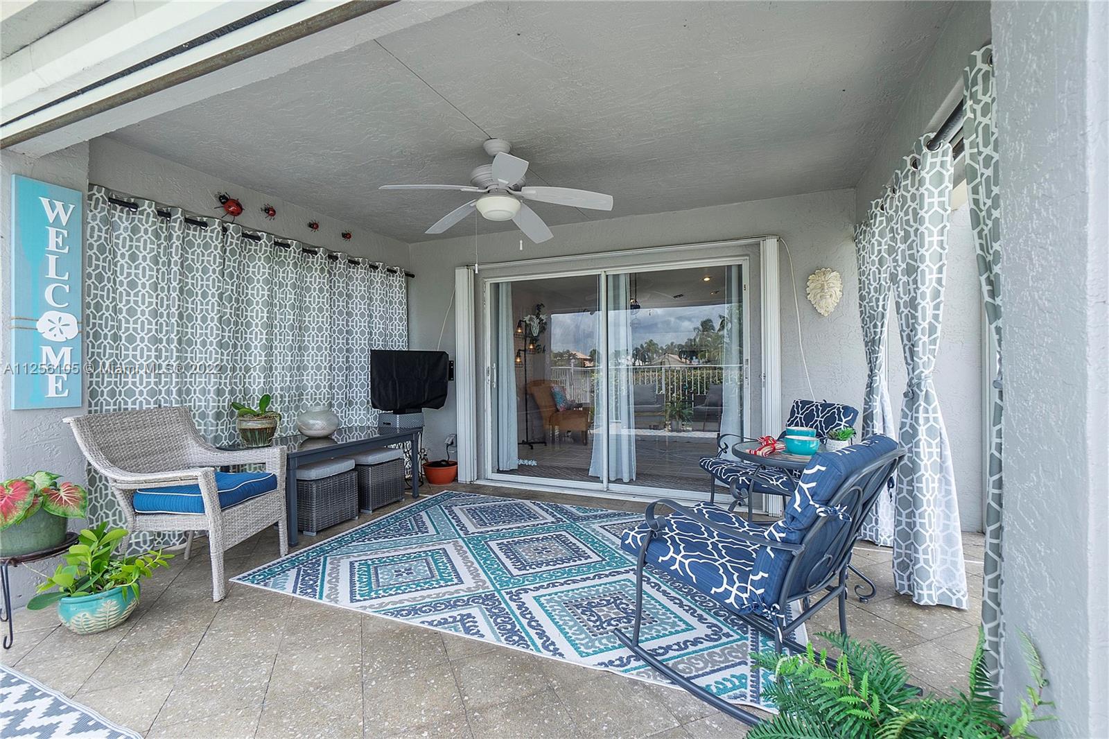 7677 Doubleton Drive Delray Beach, FL 33446 - Photo 9 of 42 a living room with furniture and a flat screen tv