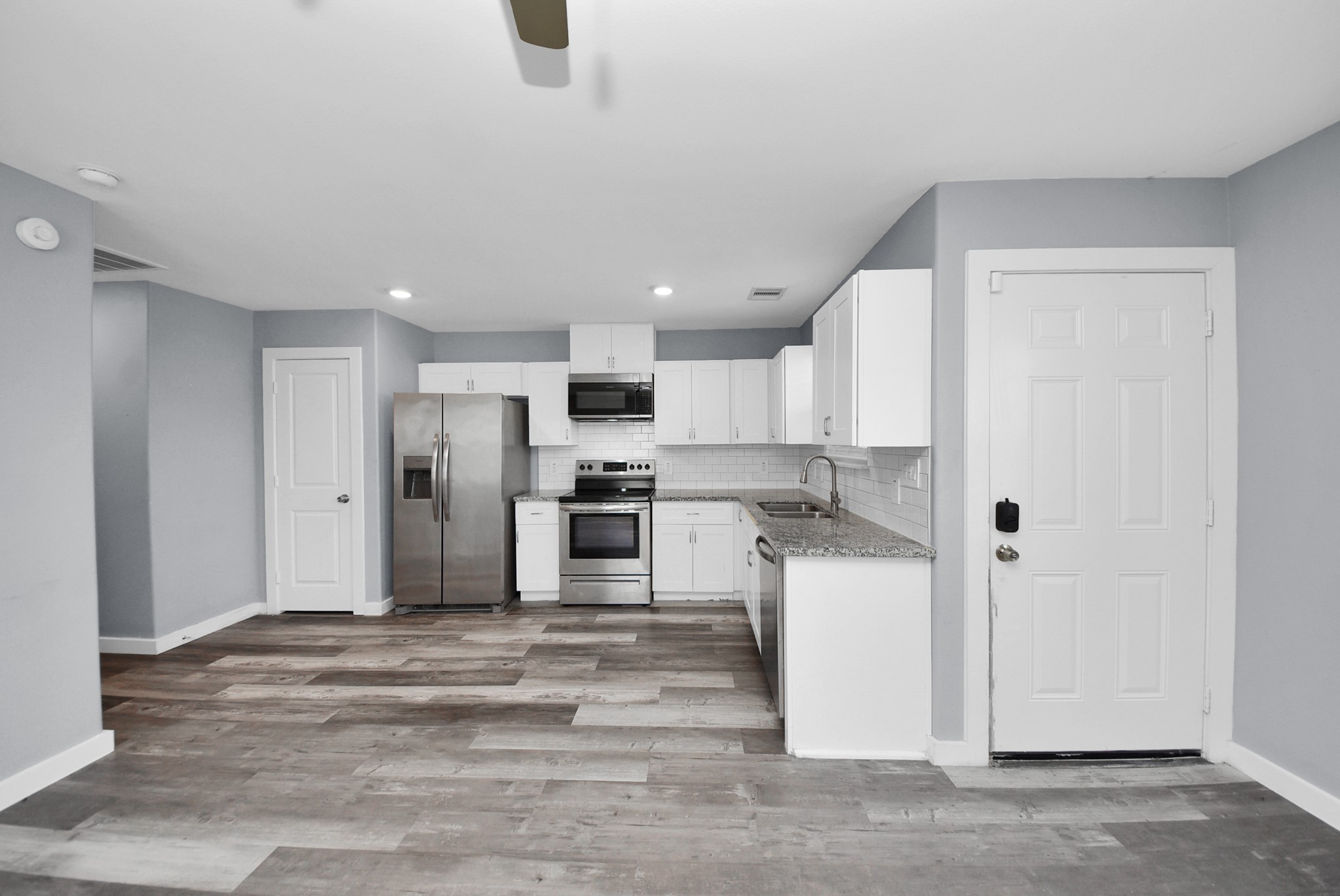 618 Maple Way, Unit A Houston, TX 77015 - Photo 12 of 48 a kitchen with a refrigerator and white cabinets