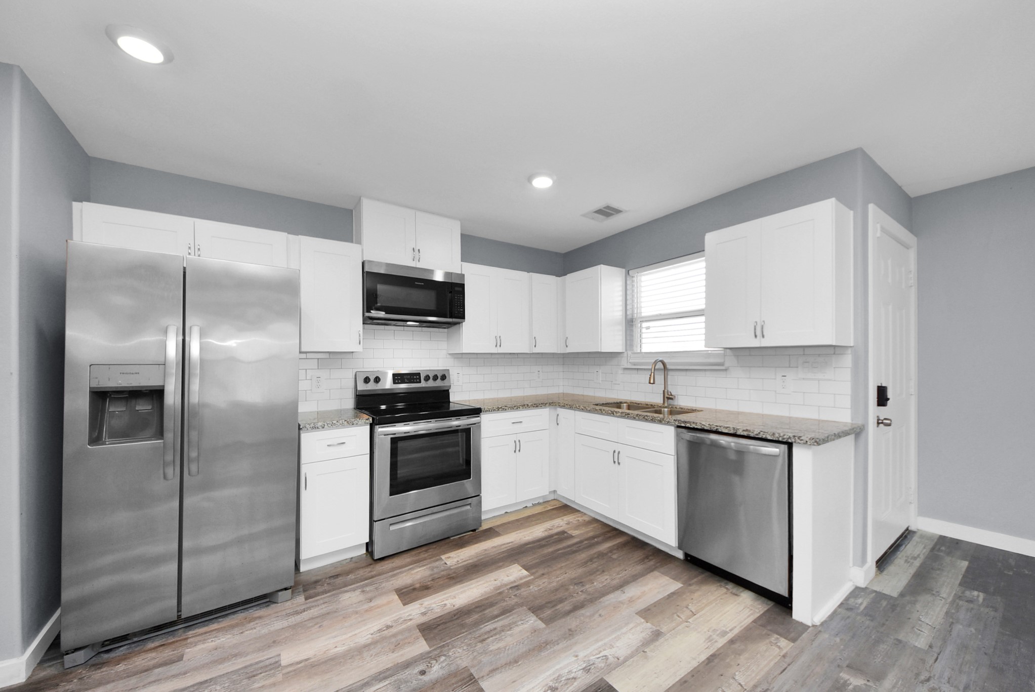 618 Maple Way, Unit A Houston, TX 77015 - Photo 13 of 48 a kitchen with stainless steel appliances granite countertop a stove a sink and a refrigerator