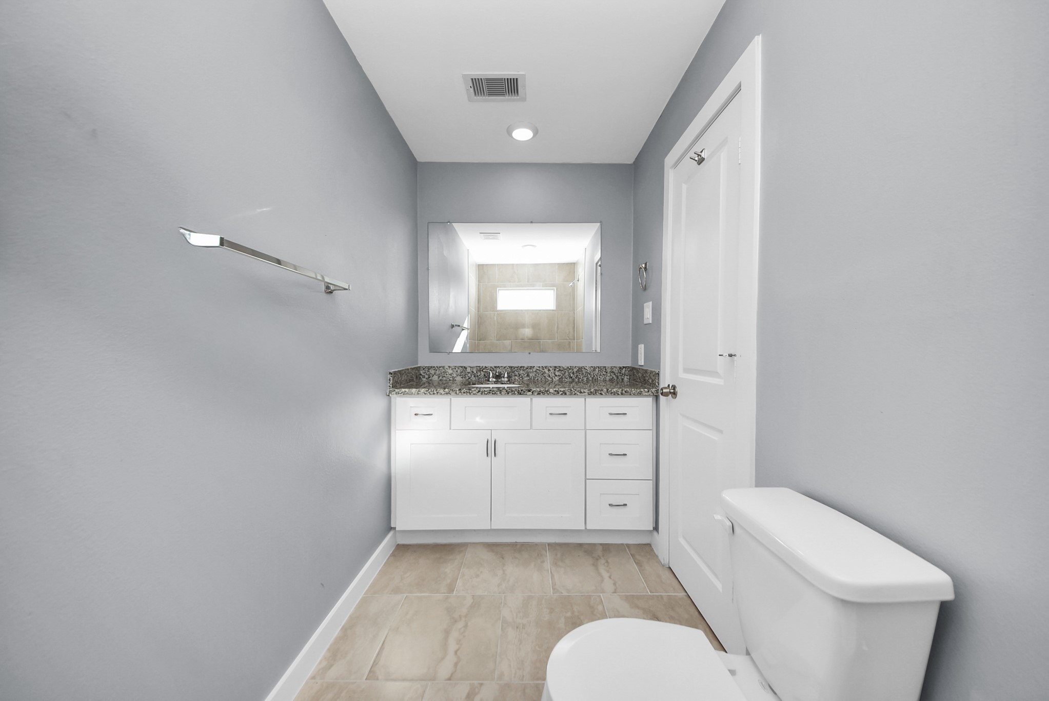 618 Maple Way, Unit A Houston, TX 77015 - Photo 27 of 48 a bathroom with a granite countertop sink mirror vanity and toilet