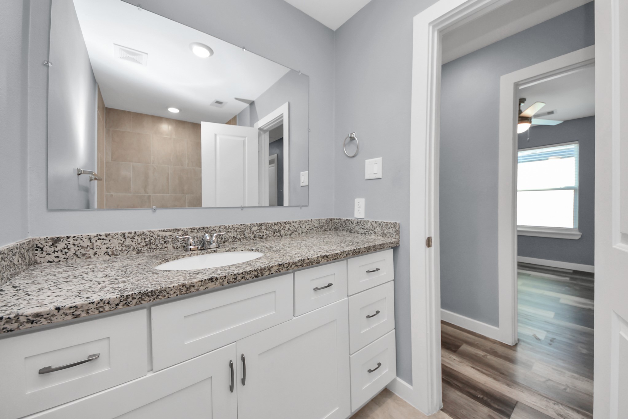 618 Maple Way, Unit A Houston, TX 77015 - Photo 29 of 48 a bathroom with a granite countertop sink and mirror