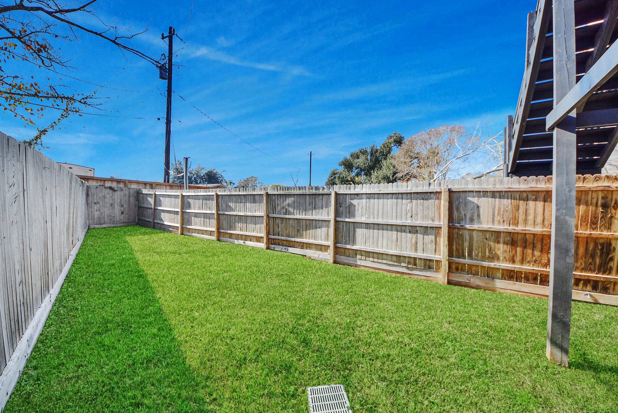 618 Maple Way, Unit A Houston, TX 77015 - Photo 44 of 48 a view of a backyard with a large tree and wooden fence