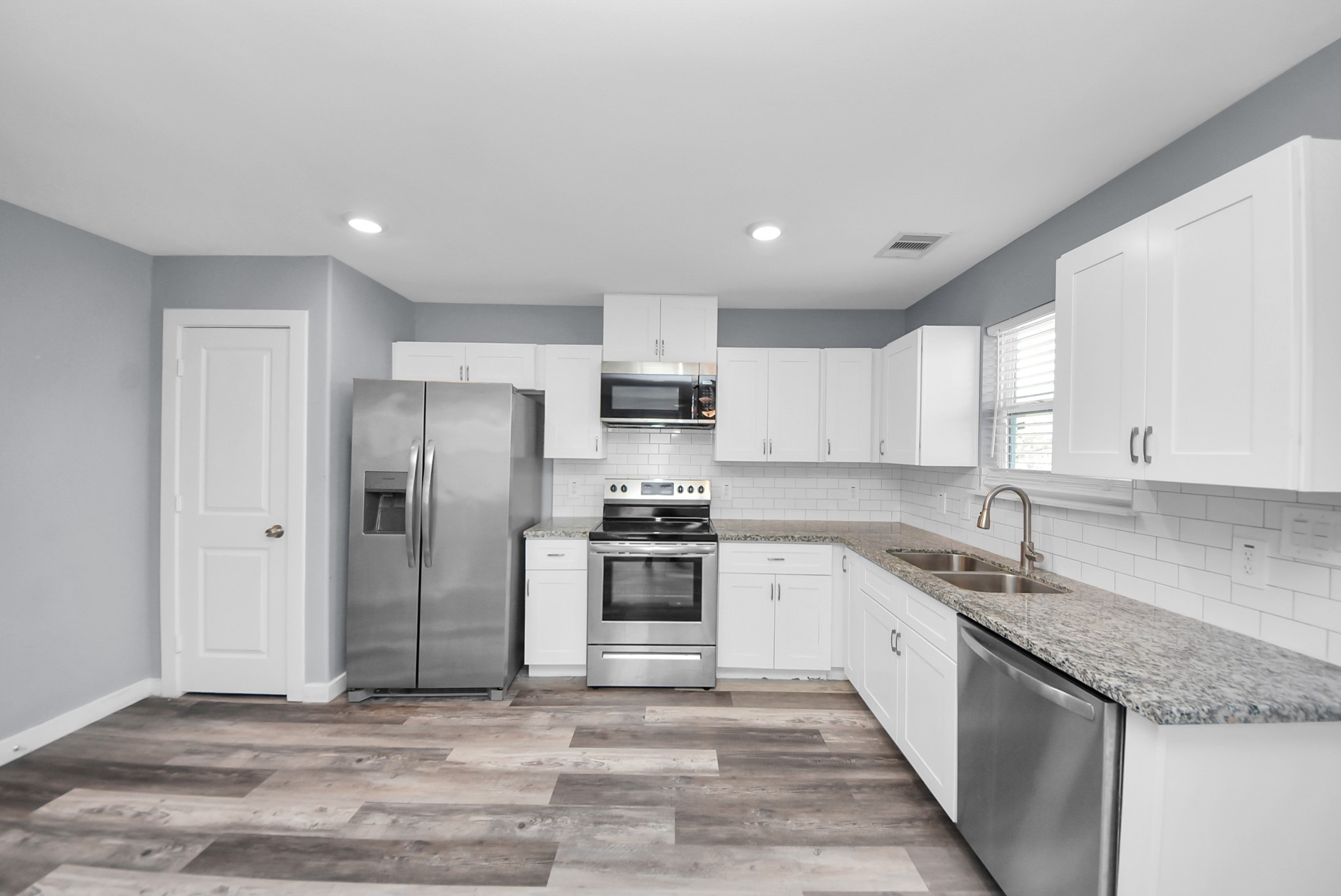 618 Maple Way, Unit A Houston, TX 77015 - Photo 8 of 48 a kitchen with stainless steel appliances granite countertop a sink stove and refrigerator