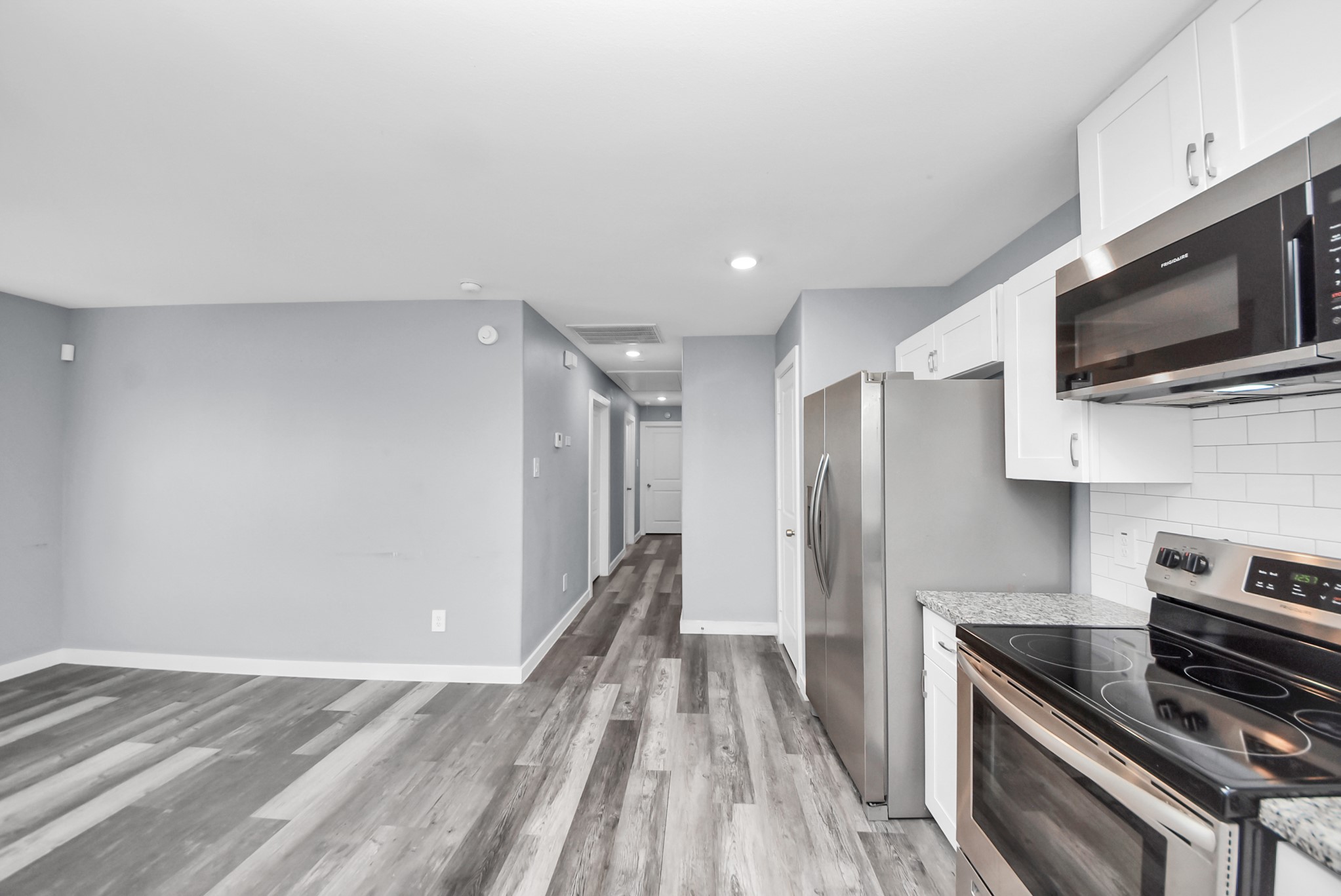 618 Maple Way, Unit A Houston, TX 77015 - Photo 10 of 48 a view of a kitchen with a sink a stove microwave and cabinets