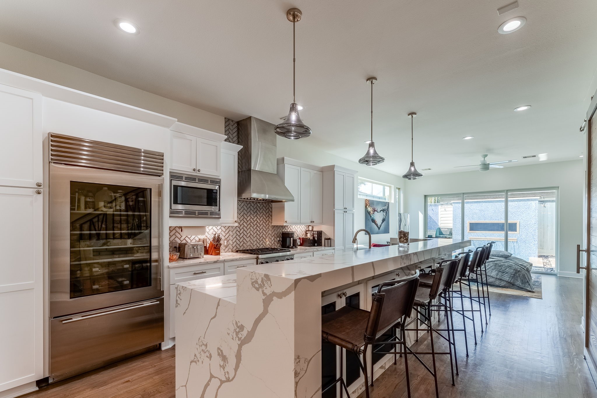 2124 Banks Street Houston, TX 77098 - Photo 12 of 46 a kitchen with stainless steel appliances kitchen island granite countertop a stove a sink and a wooden cabinets