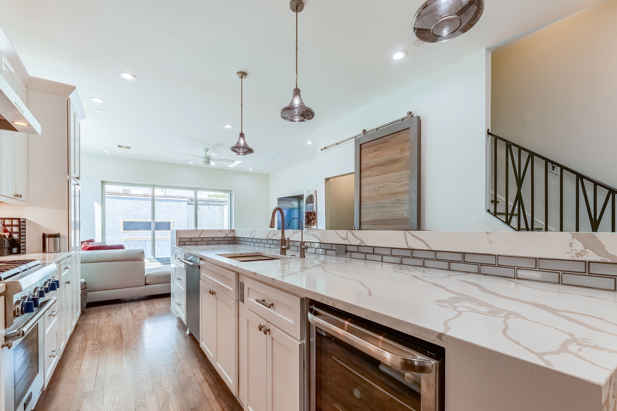 2124 Banks Street Houston, TX 77098 - Photo 13 of 46 a kitchen with stainless steel appliances granite countertop a sink a stove and a wooden floors